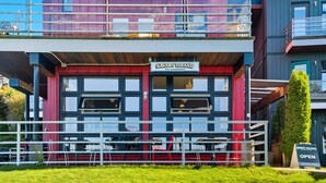 A two-story building with a sign reading 'Savary Island Pie Company.' - Fred Tibbs #10-Ocean View, D.T, Fireplace, Pets (Tofino)