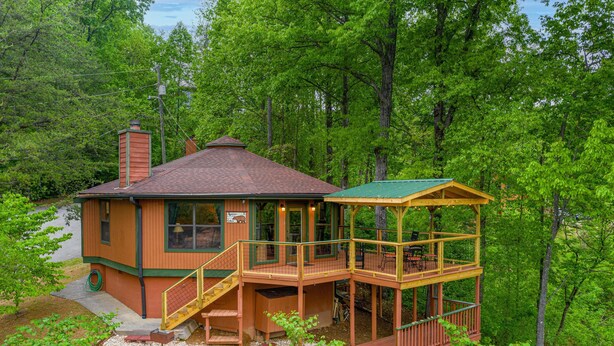 A cabin with a two-story deck, a chimney, and a porch with outdoor seating. - Spectacular Smoky Mtn. Views from Oversized Hot Tub Close to Downtown Gatlinburg (Gatlinburg)