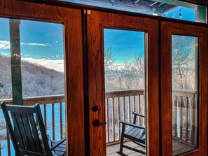 A wooden door with glass panels, a bench, and a view of a snowy landscape. - Modern Cozy Home at Powderhorn Mountain Resort with AMENITIES (Mesa)