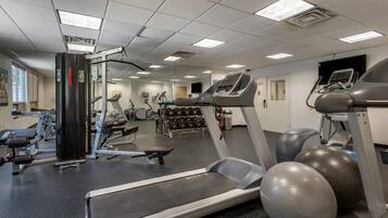 A gym with treadmills, exercise balls, and weight machines.