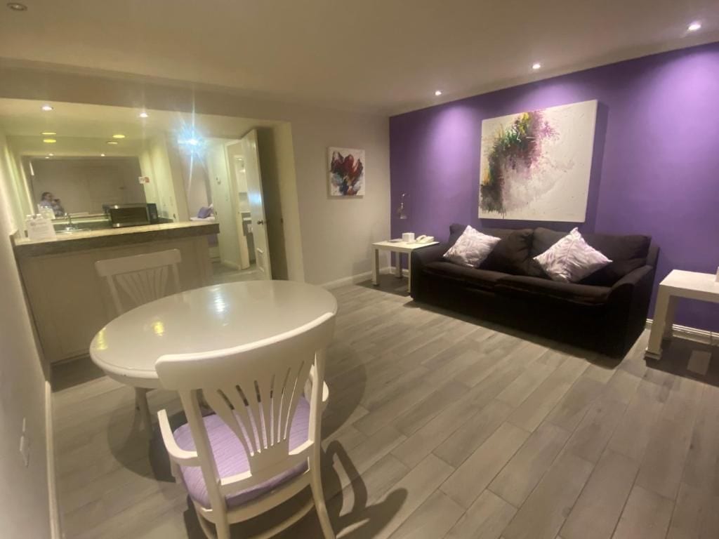 A modern living room with a dining area, a sofa, and a coffee table.