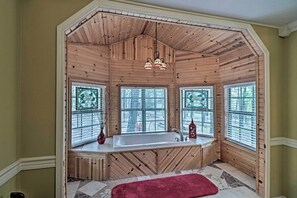 A bathroom with a wooden interior, a large bathtub, and three windows with blinds. - Secluded Edgemont Getaway w/ Huge Outdoor Deck! (Edgemont)