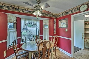A dining room with a round table, wooden chairs, and a ceiling fan. - Secluded Edgemont Getaway w/ Huge Outdoor Deck! (Edgemont)