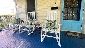 A porch with three rocking chairs, a mailbox, and a door with a wreath. - Walk to Washington St. Mall (West Cape May)