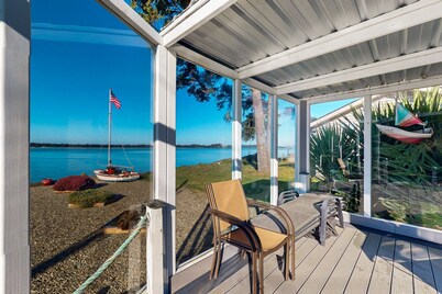 Waterfront home with panoramic bay views, deck, fireplace & beach access