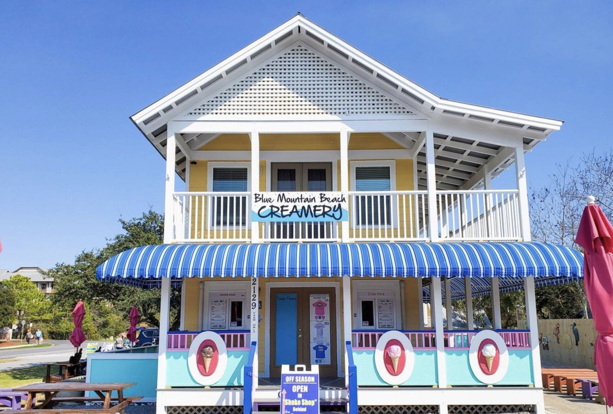 A two-story building with a sign reading "Blue Mountain Beach Creamery."