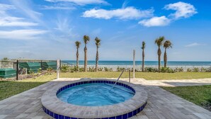 A hot tub with a view of the ocean and palm trees. - Luxury Oceanfront Condo in Daytona Beach Shores with Gorgeous Views! 4BR, 3BA (Daytona Beach Shores)
