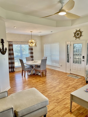 Relax in a spacious room with a dining area, seating area, and ceiling fan.