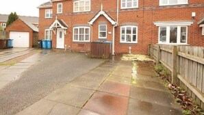 A two-story brick house with a garage, a front yard, and a wooden fence. - Fantastic 2-Bed House in Hull. Garden, Sky tv. (Hull)
