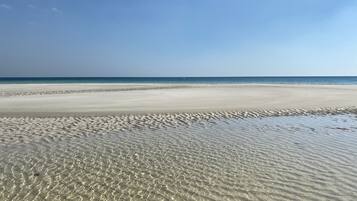 On the beach, sun-loungers, beach umbrellas, beach towels