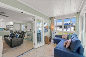 A spacious living area with a sofa, a recliner, and a dining table. - Private Beach Villa: Modern Luxury at Crystal Sand (Siesta Key)