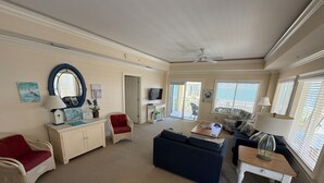 A spacious living room with a sofa, armchair, and a small table. - 3 bedroom,baths, Pool, Land Trans from Dock, 4 passenger golf cart included! (Daufuskie Island)