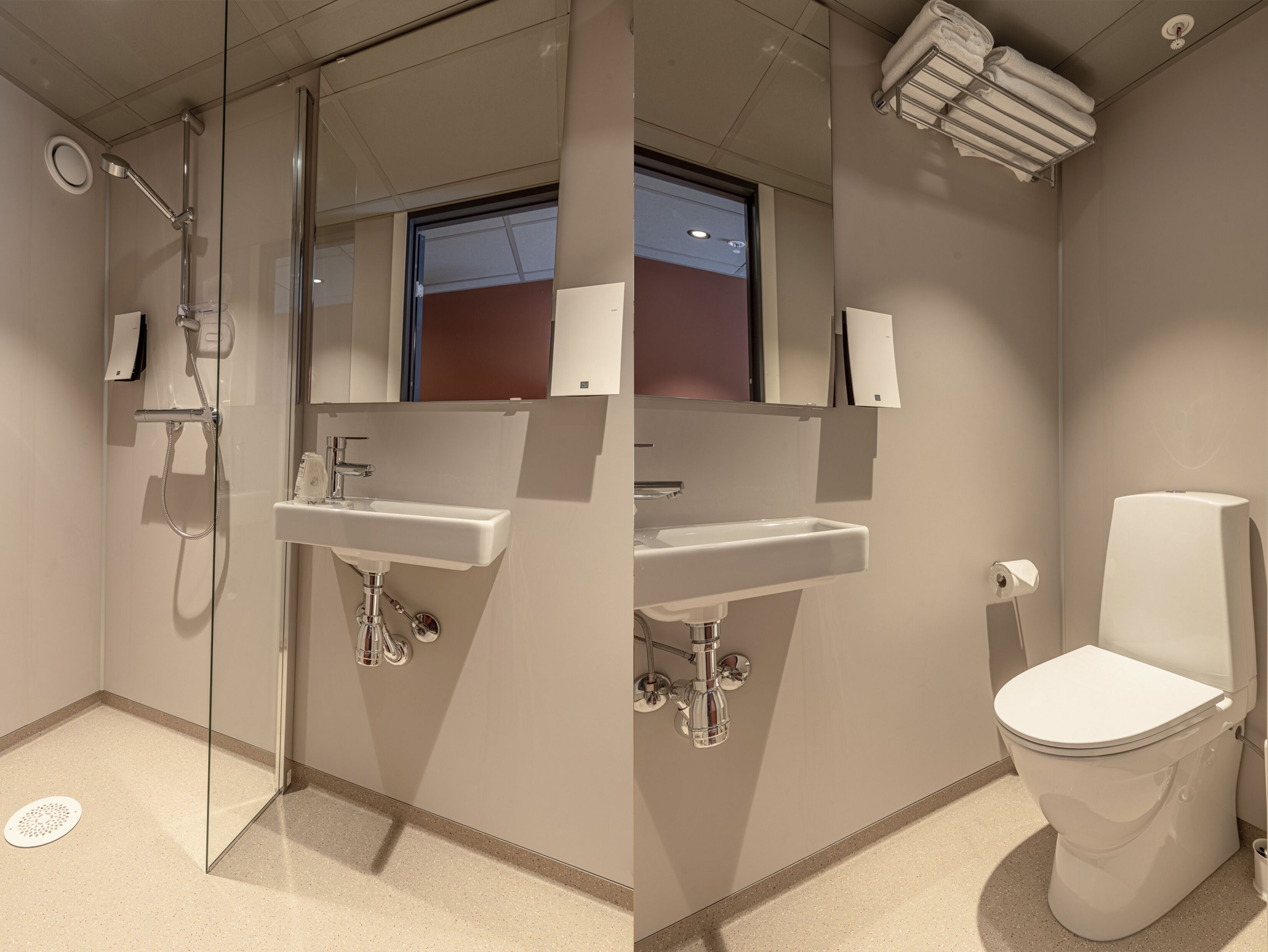 A modern bathroom with a glass-enclosed shower, a sink, and a toilet.