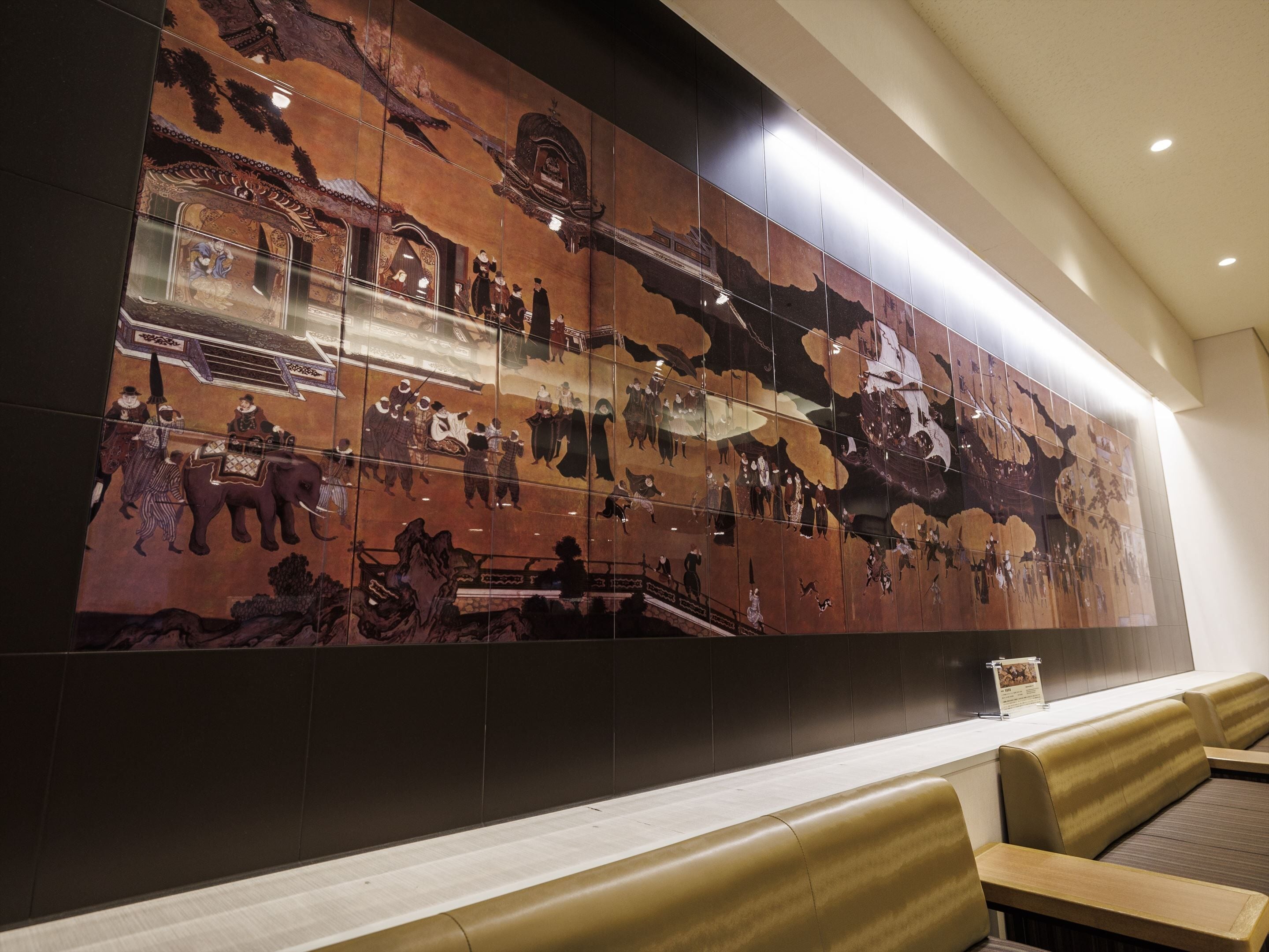 A wall mural depicting a historical scene with figures and animals.