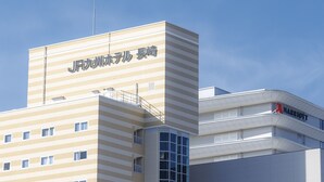 Hotellirakennus, jonka edessä on kyltti japaniksi.
