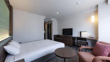 A hotel room with a bed, a desk, a television, a chair, and a small table.
