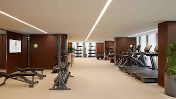 A modern gym with treadmills, weight machines, and a variety of fitness equipment.