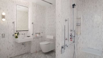 A modern bathroom with a white sink, toilet, and shower.