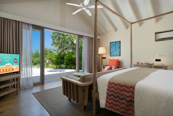 A modern hotel room with a large bed, a television, a desk, and a view of the outdoors. - Cora Cora Maldives-Premium All-Inclusive (Maamigili Island)