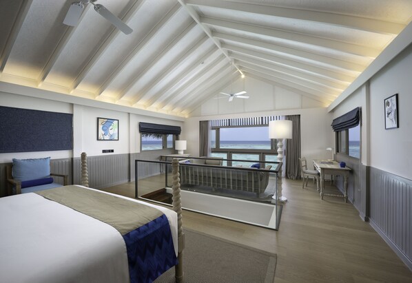 A modern hotel room with a balcony, a bed, a desk, and a view of the sea. - Cora Cora Maldives-Premium All-Inclusive (Maamigili Island)