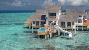 Overwater bungalows with thatched roofs, a pool, and wooden walkways over clear turquoise water. - Cora Cora Maldives-Premium All-Inclusive (Maamigili Island)