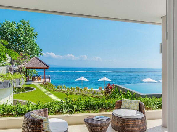 A balcony with wicker furniture, a small gazebo, and a view of the ocean. - Villa Tirta Nila by Elite Havens (Manggis)