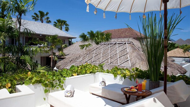 A resort with outdoor seating, a thatched-roof structure, and lush greenery. - Villa Adasa (Seminyak)