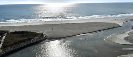 A coastal beach with a clear sky and a calm sea.