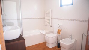 Een bidet, handdoeken, zeep, toiletpapier