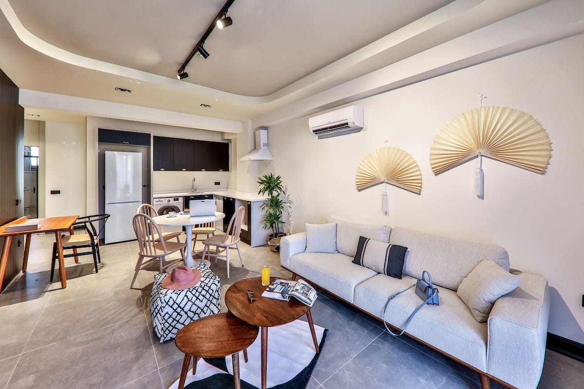 Una sala de estar moderna con sofá, mesa de centro y comedor.