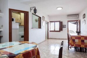 Enjoy meals in this dining area with a large table, mirror, and fan.