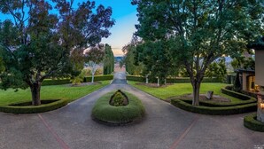 A landscaped pathway leading to a building with a well-maintained lawn and trimmed hedges. - Awesome Hilltop Views, Pool, Vineyards, Olive Trees, 5 mins to Healdsburg (Healdsburg)