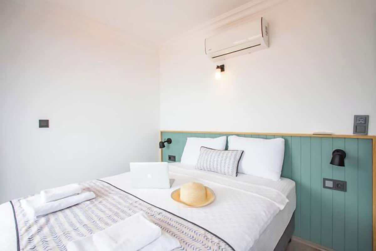 Premium bedding, desk, laptop workspace, soundproofing