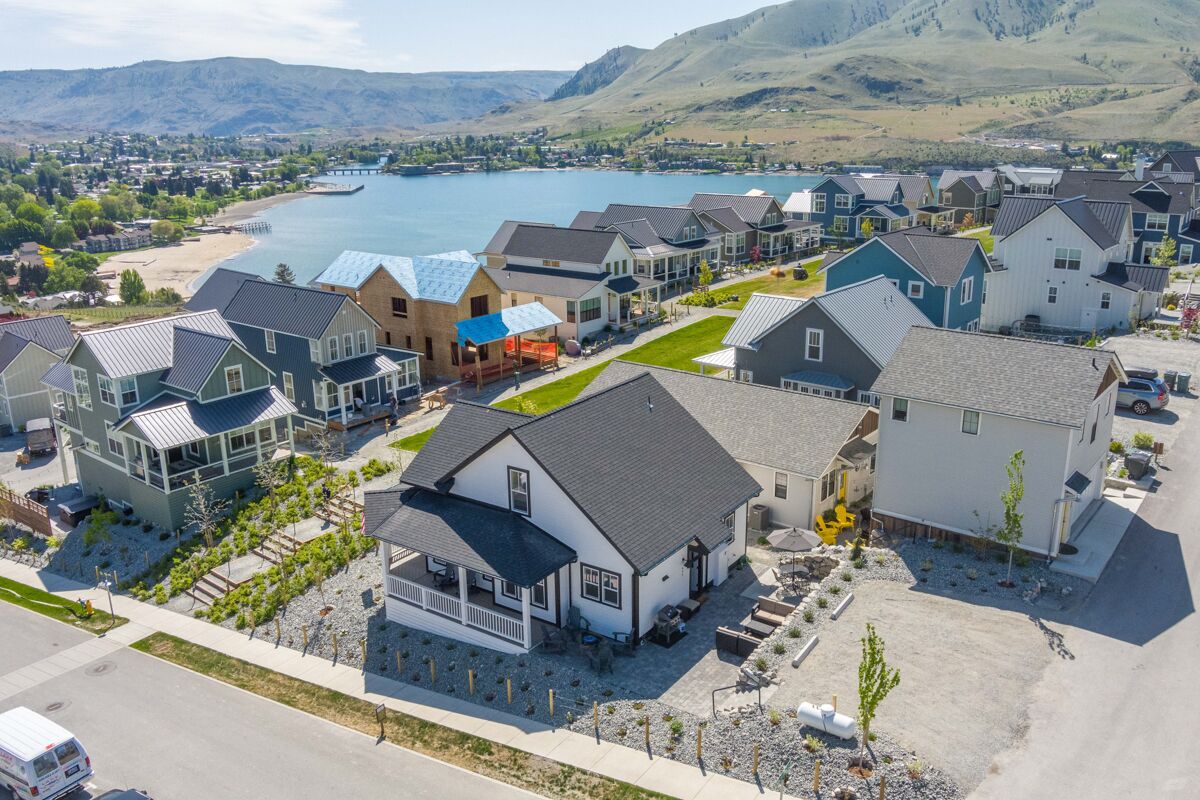 A residential area with houses, a dock, and a lake.