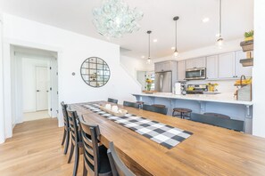 A modern kitchen with white cabinets, a central island, and pendant lighting. - Days Like This at The Lookout at Lake Chelan (Chelan)