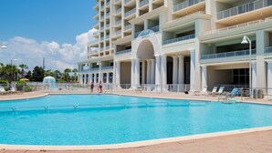 A hotel with a large pool, multiple balconies, and a clear sky. - Seascape ~ Gulf View ~ Bunk Area (Miramar Beach)