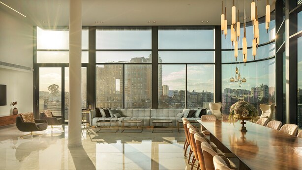 A spacious living room with a large sofa set, a dining table with chairs, and a city view through floor-to-ceiling windows. - ⚜ EVEN ISRAEL PENTHOUSE ⚜JACUZZI⚜5 royal Masters⚜ (jerusalem)