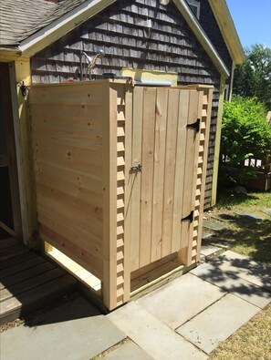Situated on a patio, this shed features a single door and a small window.