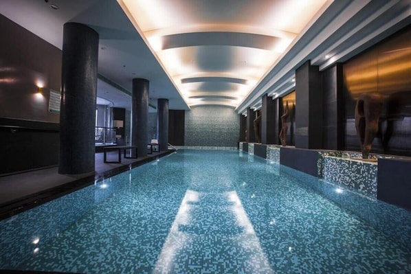 Relax by the pool surrounded by sleek lines and a unique mosaic tile pattern.