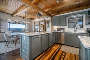 Enjoy cooking in this well-equipped kitchen with a central island, oven, and sink.