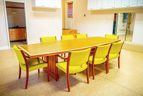 A dining area with a wooden table and yellow chairs.