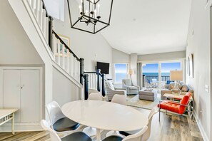 Relax in this stylish living area with a round table, comfortable chairs, and a flat-screen TV.