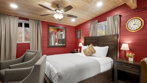 A bedroom with a bed, two chairs, a nightstand, a lamp, a clock, and a ceiling fan. - 19 Creekside Retreat (Sedona)