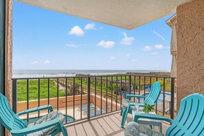 A balcony with a view of the ocean, equipped with chairs and a small table. - Carolina Reef 101 - 2 Bedroom Ocean Front Condo (North Myrtle Beach)
