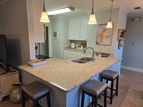 2 Bed/2 Bath, 1 Level, screened porch on double green with 4 seater golf cart