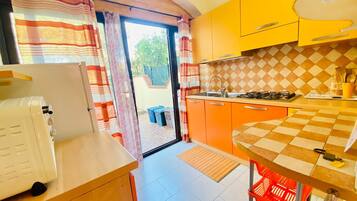 Apartment, 2 Bedrooms | Private kitchen | Full-sized fridge, stovetop, cookware/dishes/utensils, dining tables