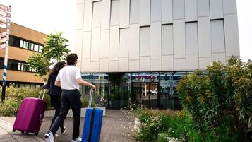 A modern building with a glass entrance and a sign for a restaurant.