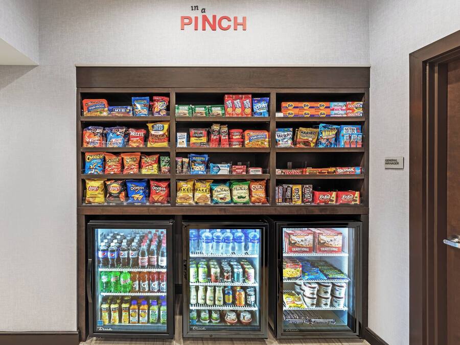 A snack and beverage vending area with various snack brands and drink options.