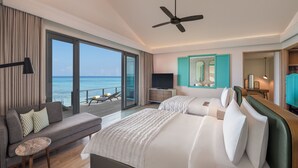 A hotel room with a bed, a sofa, a TV, a ceiling fan, and a view of the ocean. - Le Meridien Maldives Resort & Spa (Thilamaafushi Island)