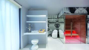 A modern bathroom with a white toilet, a vanity with a mirror, and a shower area with a glass door.
